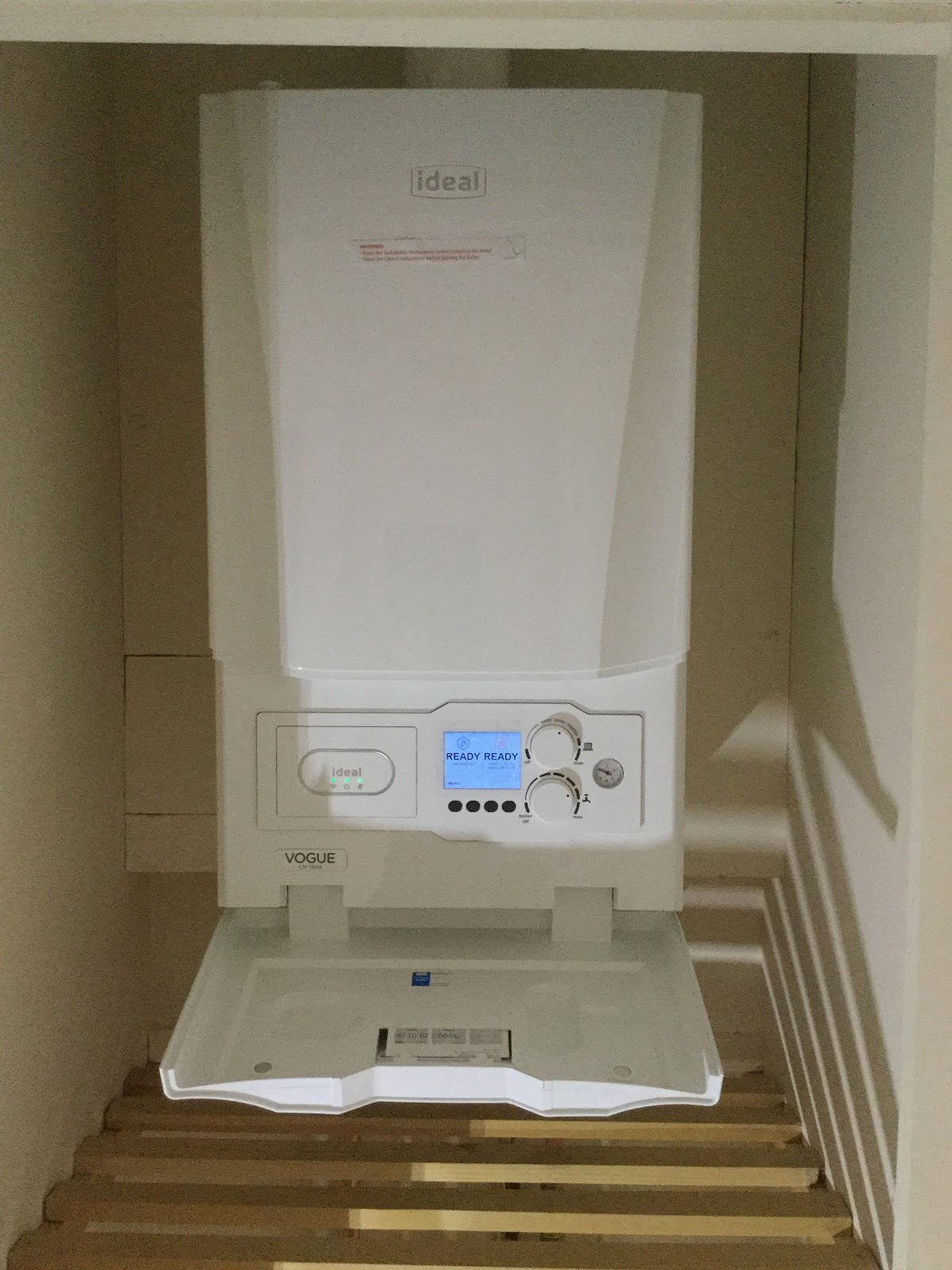 A close view of an Ideal boiler with its user control flap open